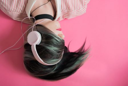 A girl listens to music on her headphones.