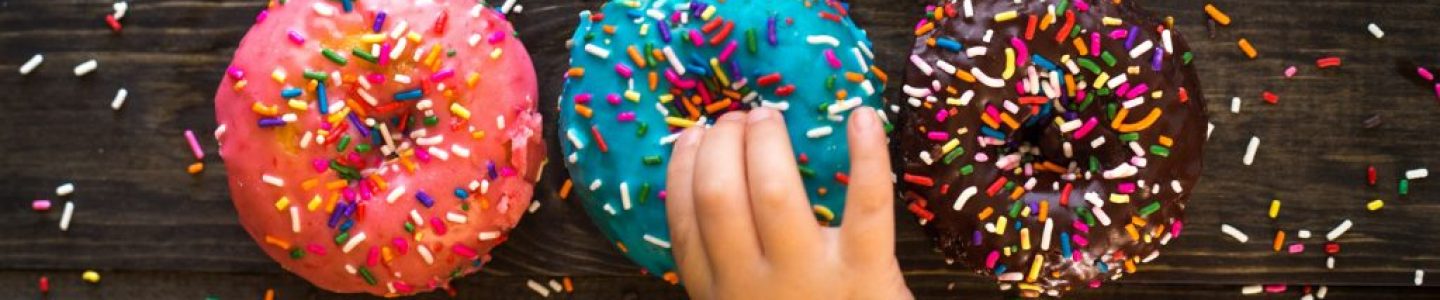 Child chooses a donut with sprinkles!